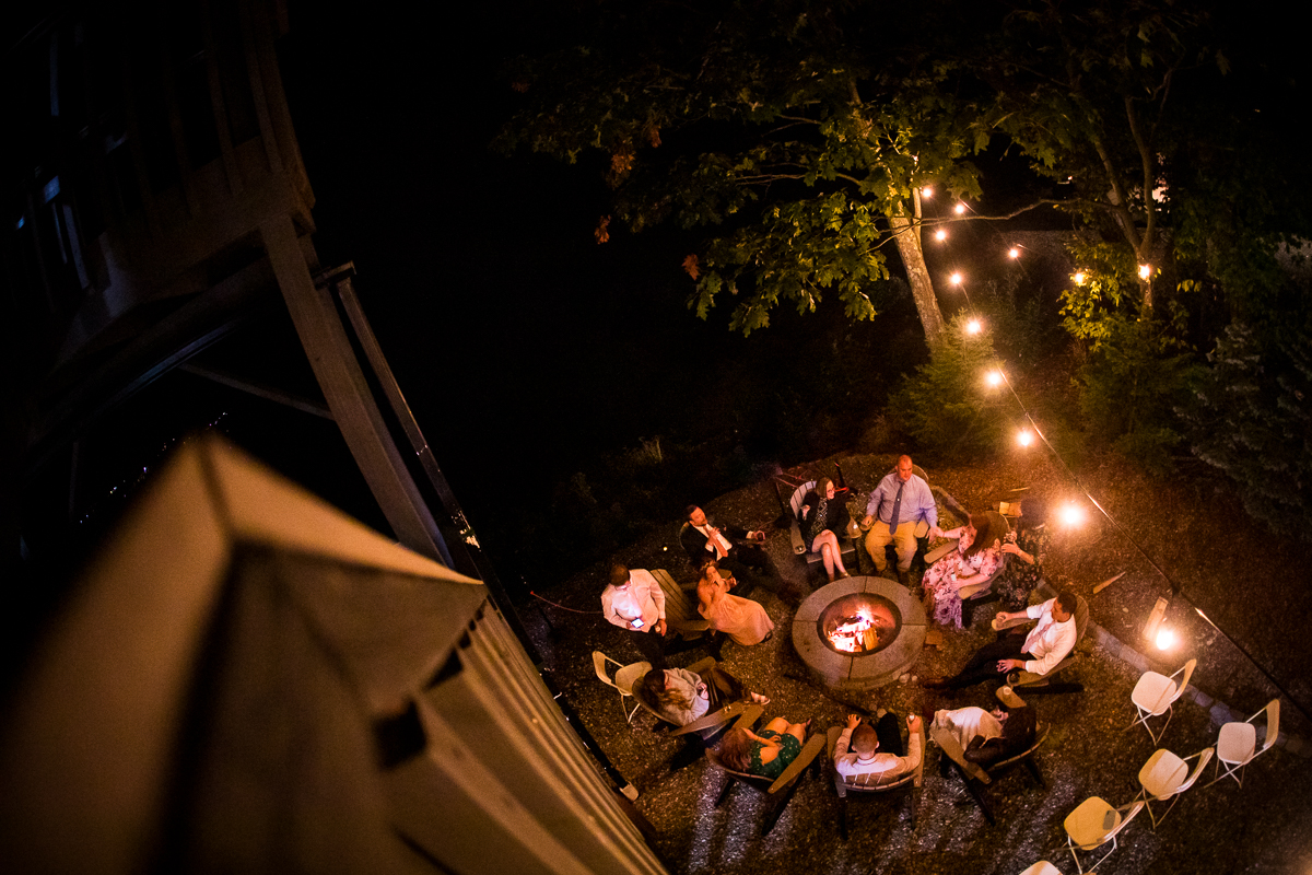 Birdseye view of wedding guests sitting around fire pit at lake raystown intimate wedding photographer best creative artistic