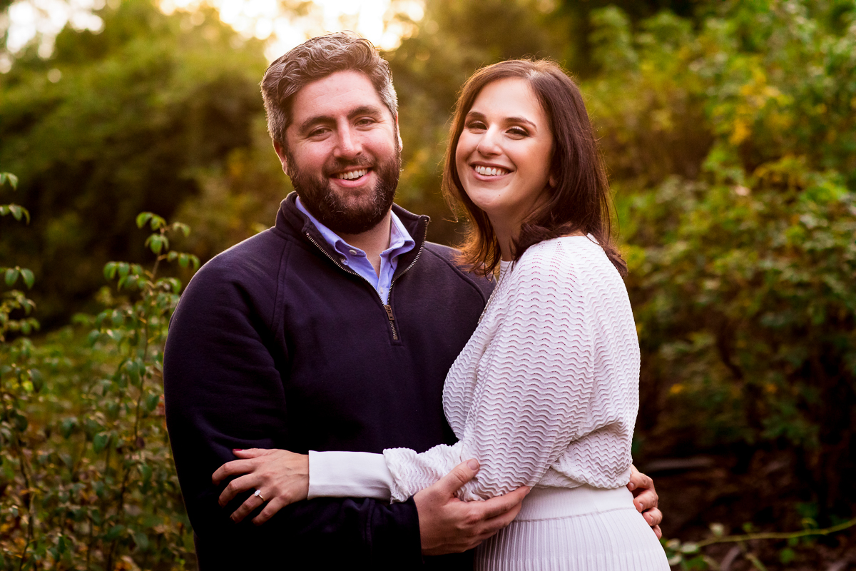 couple smiling staring at camera traditional engagement portrait