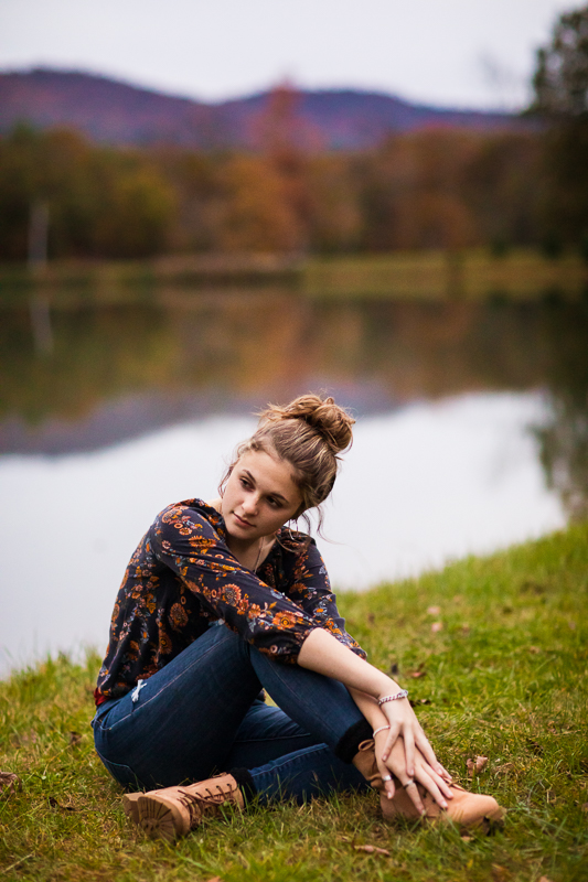 girl sitting in front of lake posing for senior portraits best creative central pa 