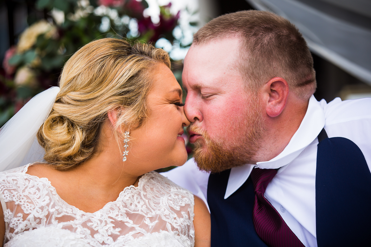 bride and groom about to share a kiss during wedding portraits 