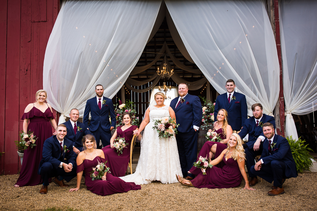 wedding party posed outside heritage restored barn creative artistic wedding photographer