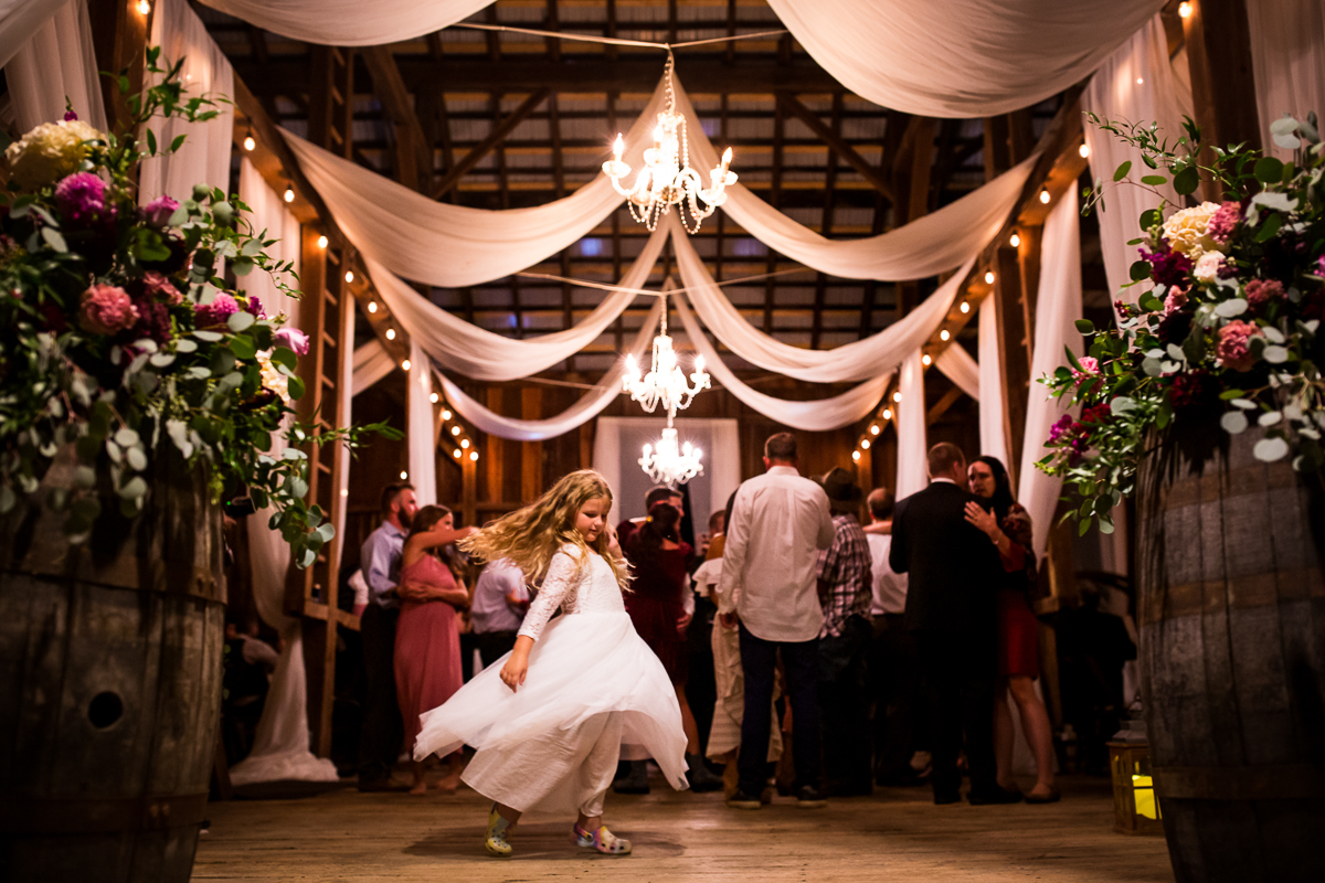 flower girl spinning at heritage restored under drapery and chandeliers