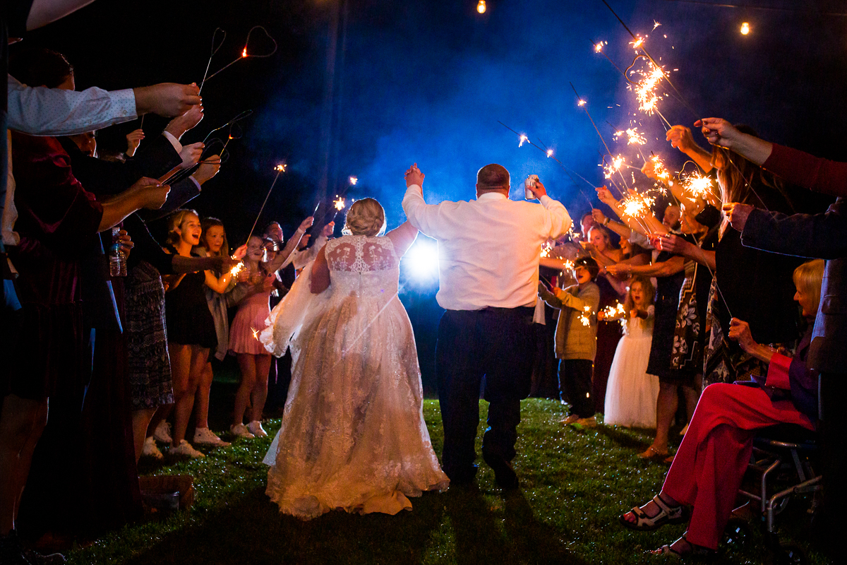 central pa wedding heritage restored bride and groom walking through sparklers