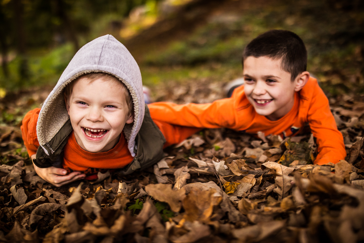 two brothers laughing while playing in pile of leaves central pa family lifestyle session