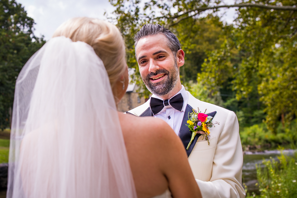 groom smiling at bride for first time on wedding day at illicks park 