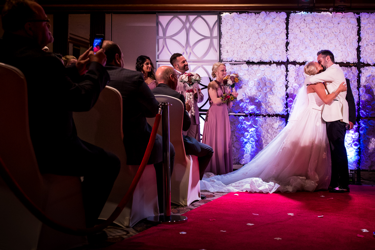bride and groom share first kiss on red carpet Hollywood themed wedding emotional authentic candid wedding photographer