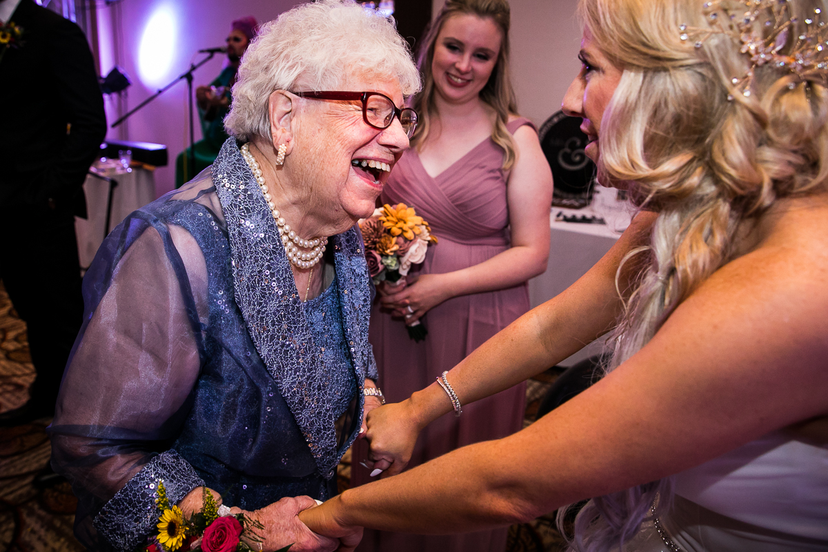 bride talking and laughing with grandma at wedding reception Lehigh Valley wedding photographer emotional candid