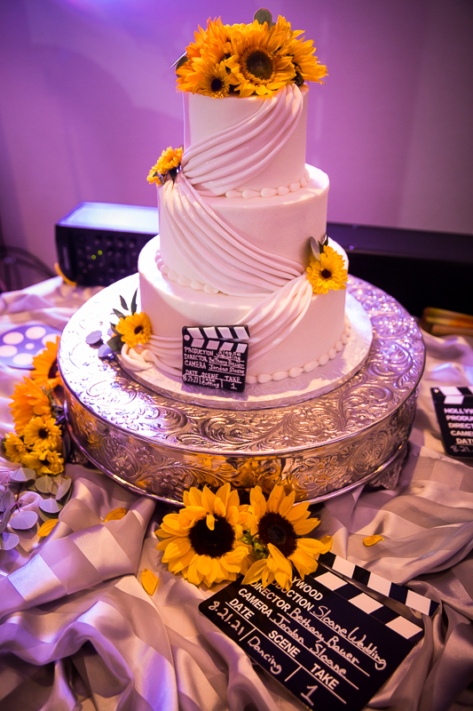 white wedding cake with sunflowers and movie scene signs Lehigh Valley conference center
