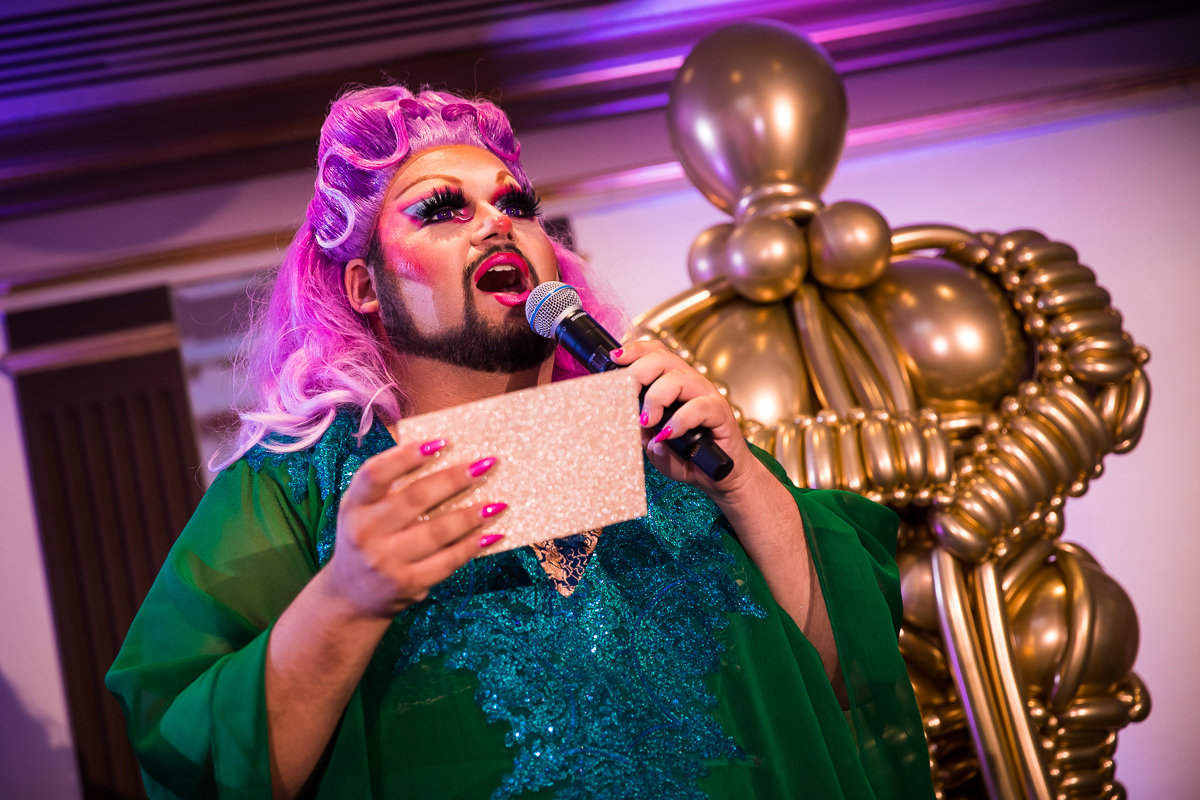 drag queen making announcement during wedding reception speeches Hollywood inspired wedding theme
