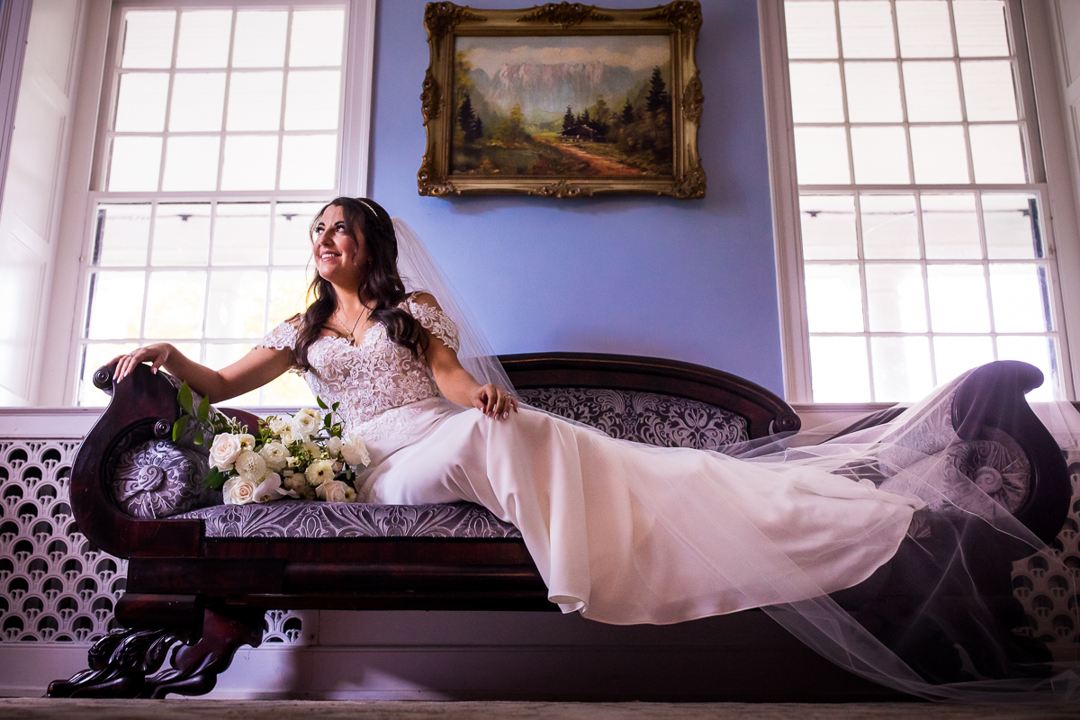 traditional bridal portrait sitting on setae in the mansion bridal suite at allenberry resort