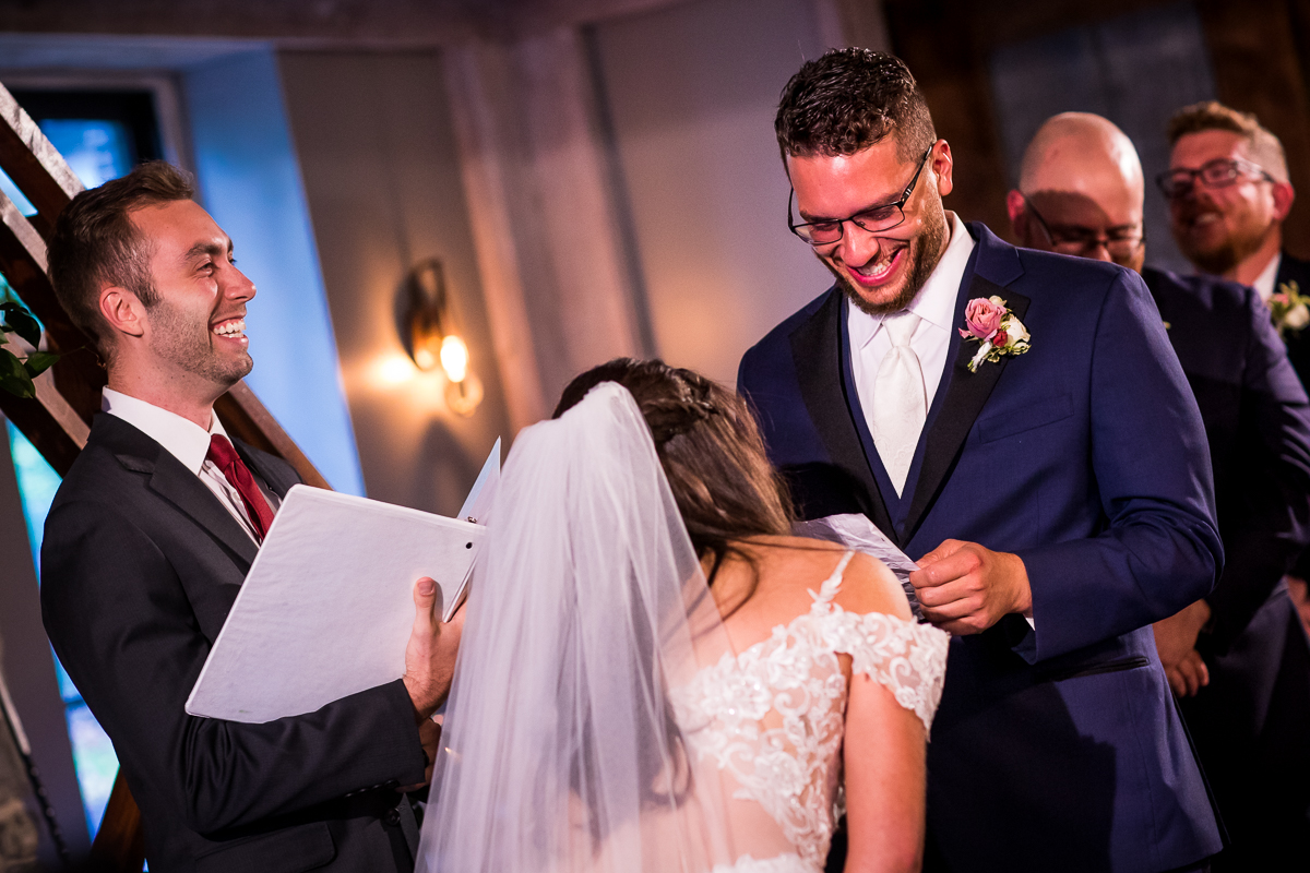emotional candid authentic wedding ceremony groom reading bride vows and guests laughing