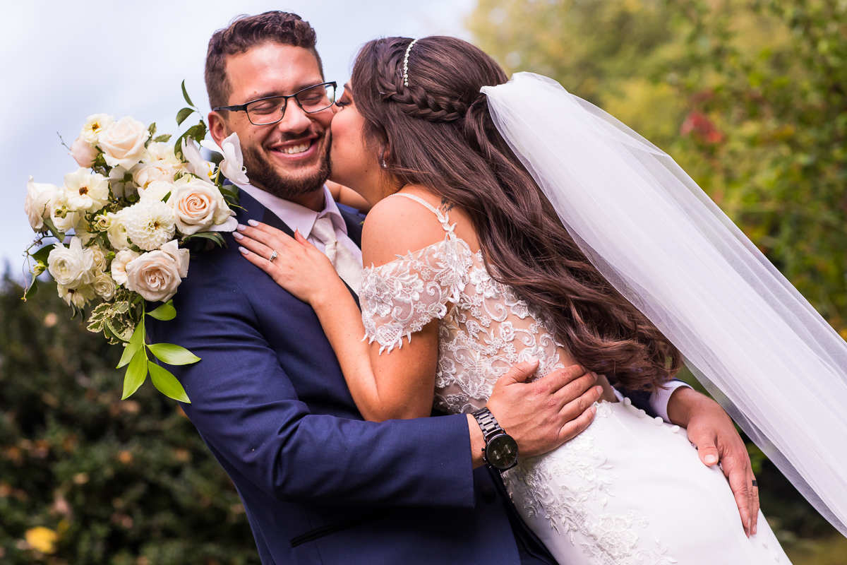 bride giving groom kiss on cheek boiling springs pa wedding photographer