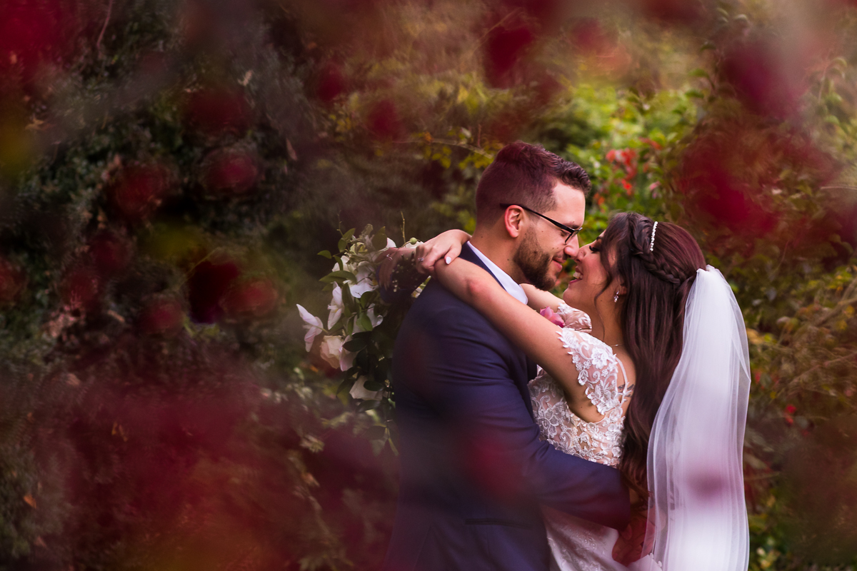 creative artistic wedding photographer central pa bride and groom smiling holding each other surrounded by flowers