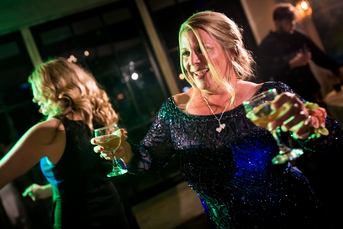 bride's mom double fisting with wine moving on to dance floor at allenberry resort wedding reception