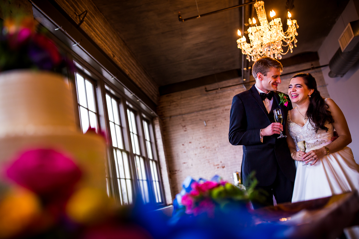 the bond wedding photographer bride and groom drinking champagne in venue space before reception starts