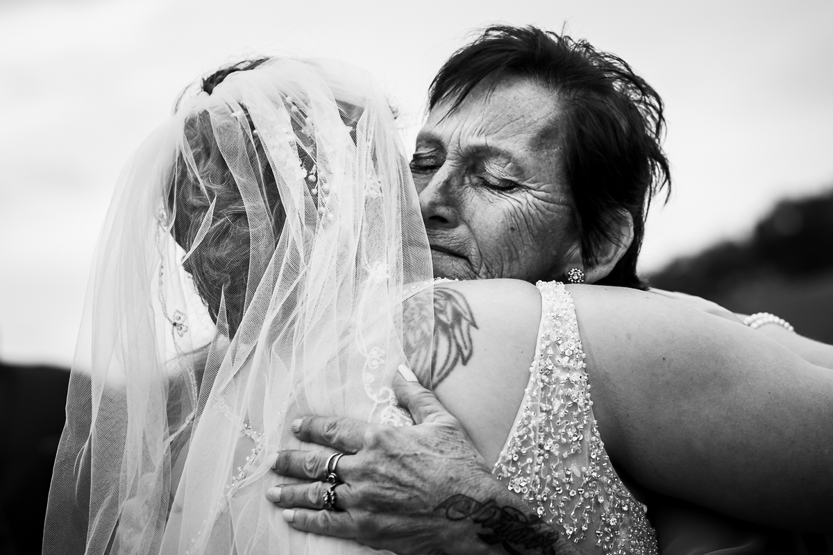 emotional authentic candid real life heritage restored wedding photographer bride hugging mom before ceremony 