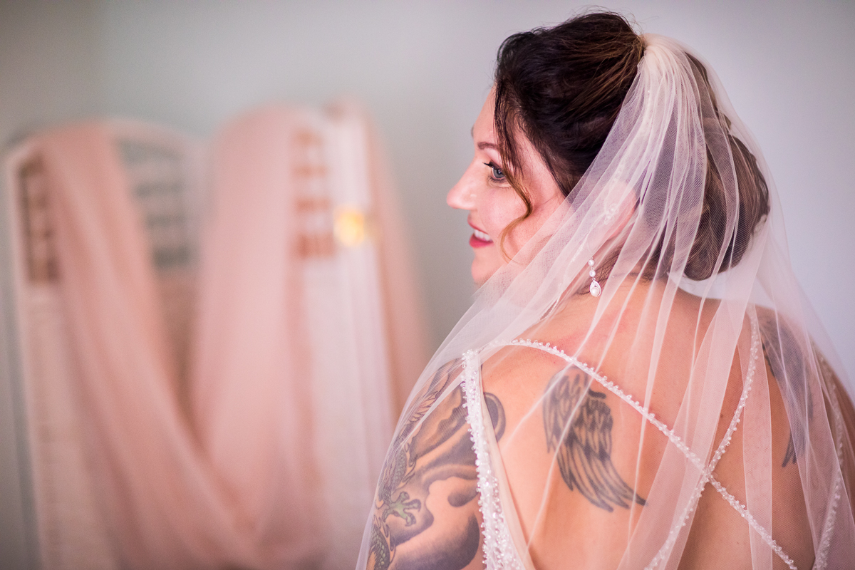 bride in bridal suite at heritage restored smiling looking over shoulder