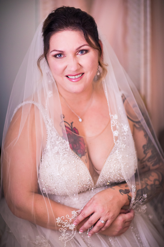 bride sitting smiling looking at camera traditional bridal portraits