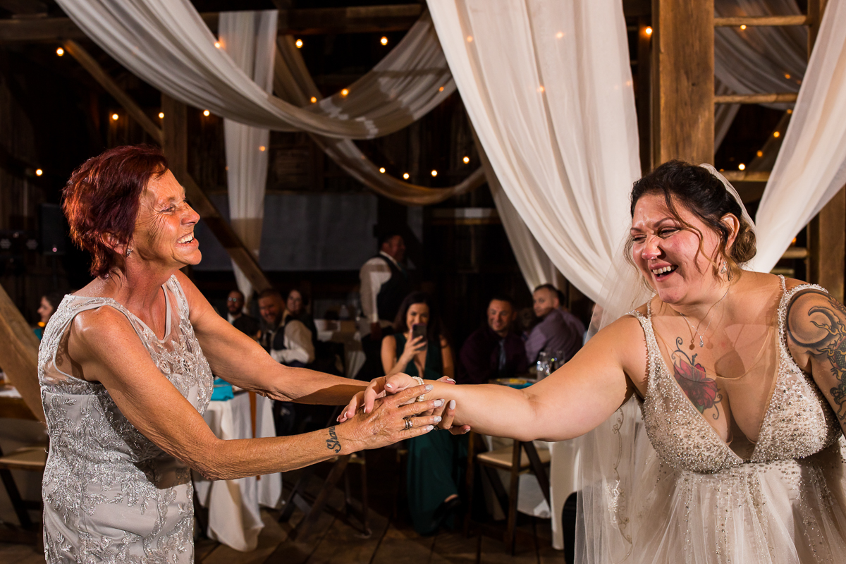 mom spinning bride during first dance at heritage restored wedding reception bride and mom smiling and laughing