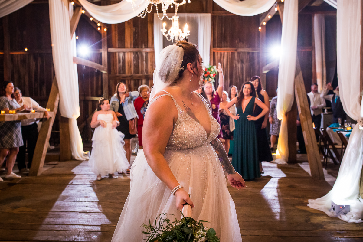 bride tossing bouquet during heritage restored wedding reception