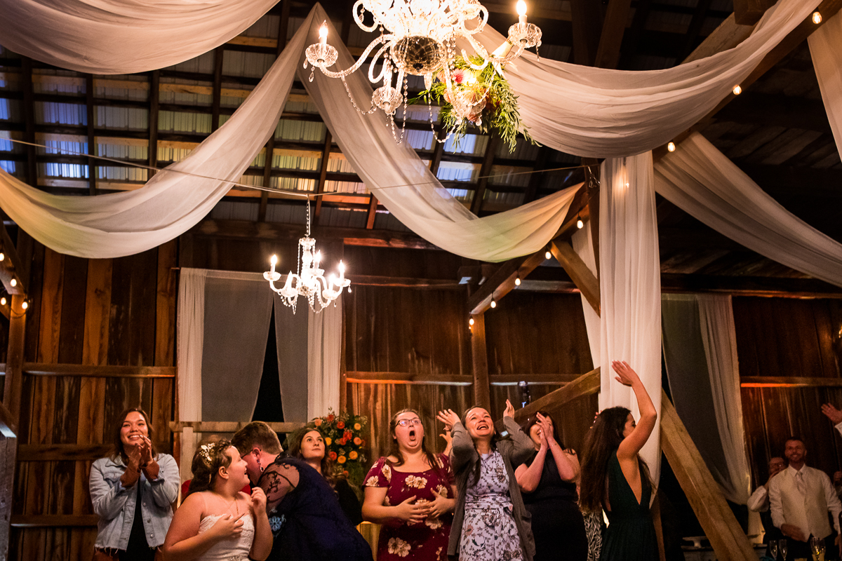guest waiting as bouquet is tossed in the air