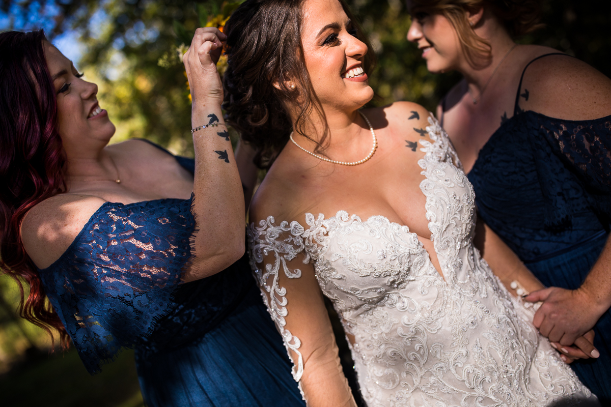 bride with sisters with matching tattoos helping her get ready at hauser hill winery