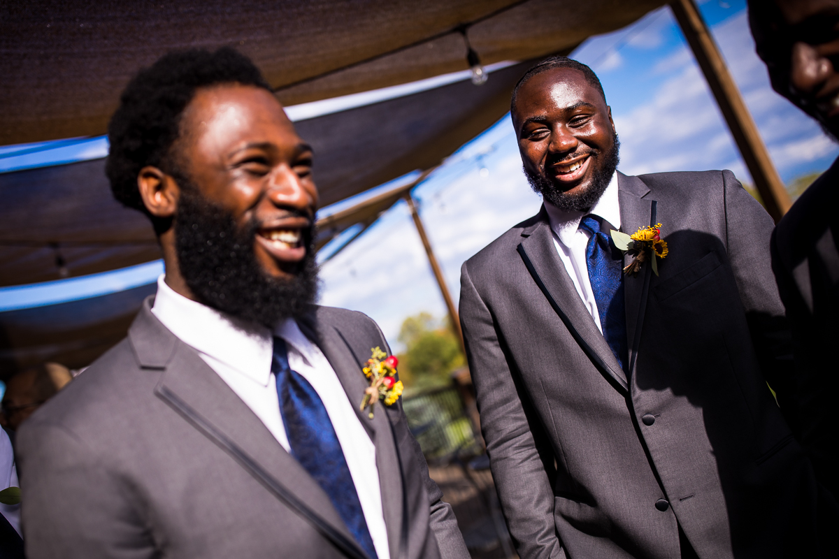 groomsmen talking and laughing together before ceremony begins