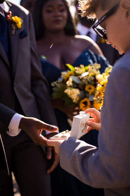 ring bearer giving rings to groom before ceremony