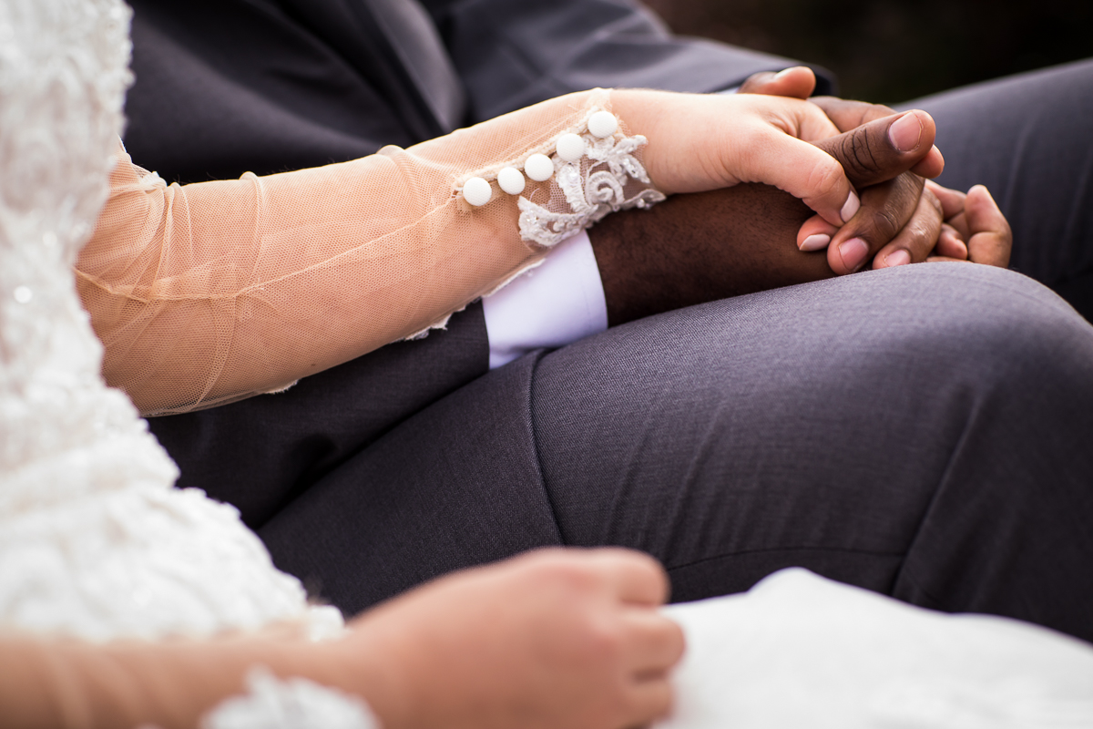 bride and groom holding hands during wedding ceremony