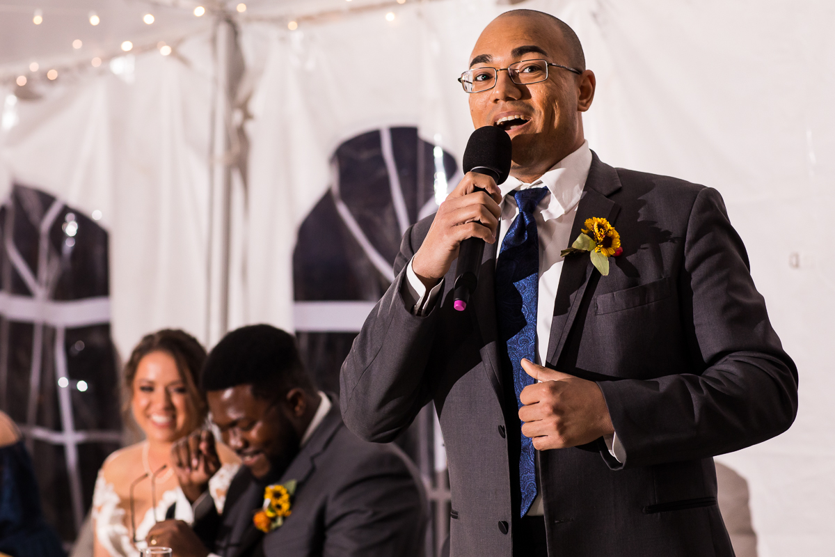 wedding party member giving funny speech during wedding traditions 