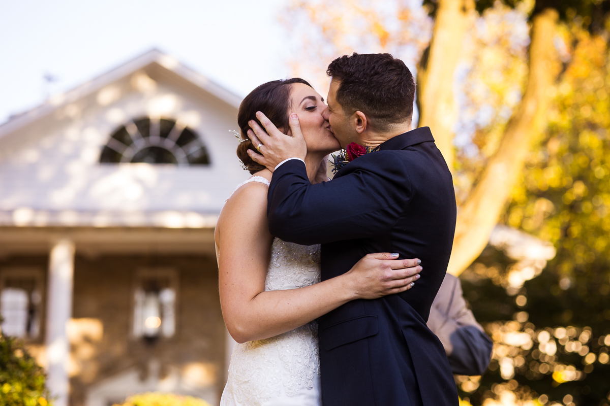 bride and groom share first kiss in front of Linwood estate wedding outdoors best central pa photographer