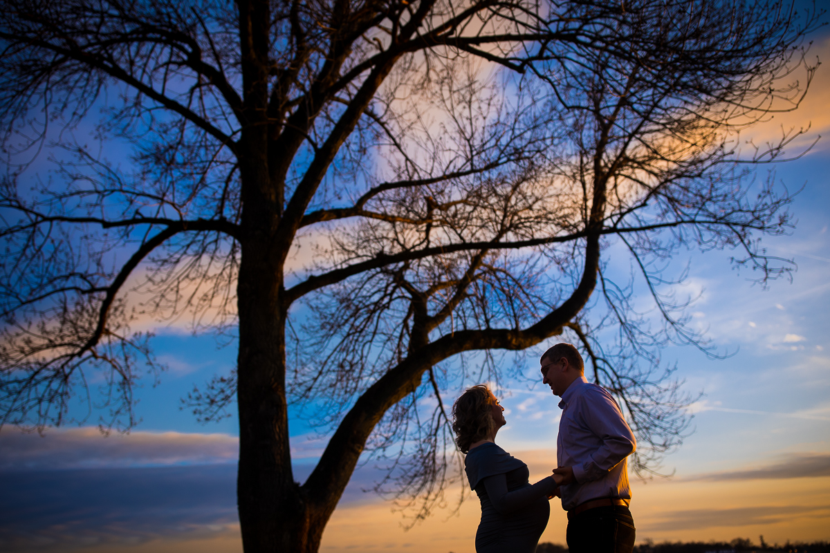Pregnant couple silhouetted along the Susquehanna as photographer by Harrisburg Maternity Photographer