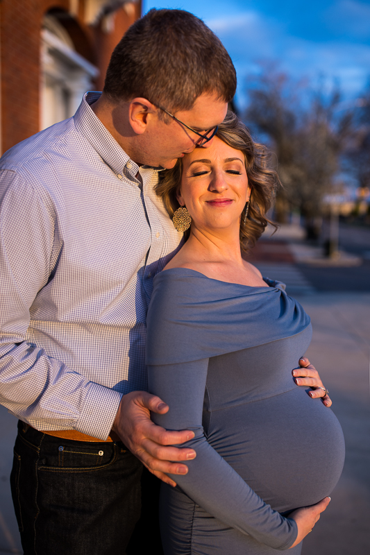 Harrisburg Maternity Photographer photographs a smiling pregnant couple at sunset