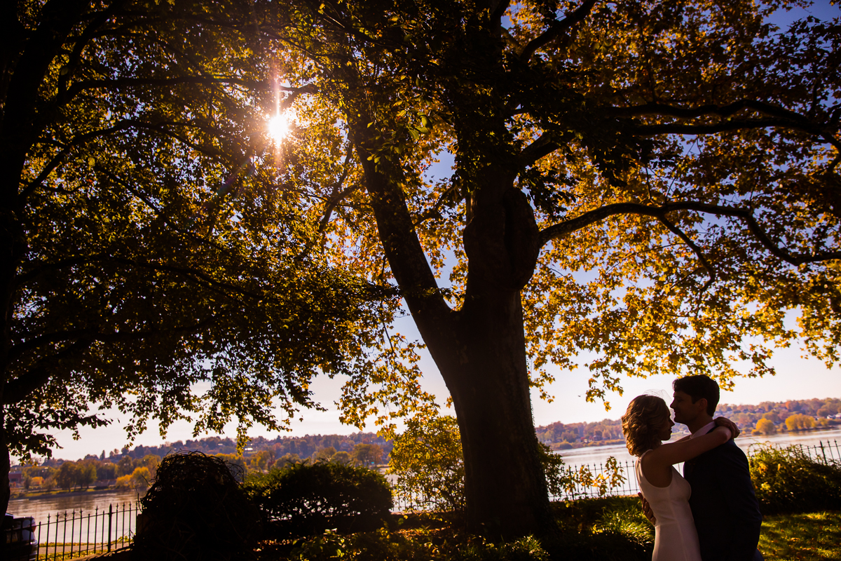 Newly wed couple getting photos taking in front of the Susquehanna River for their Civic Club of Harrisburg wedding