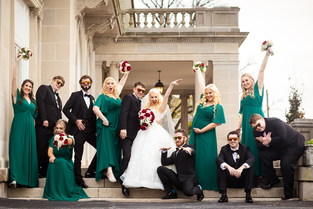 Bride, Groom and Wedding Party in green and black posing for a group photo outside of King Mansion Harrisburg