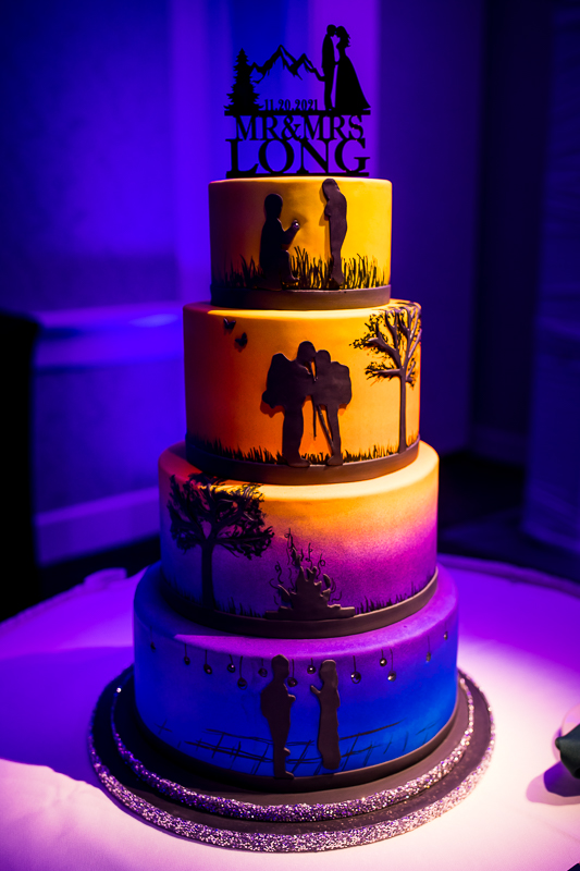 Bright and colorful photo of the couple's multiple tiered wedding cake at their wedding reception at Best Western Harrisburg