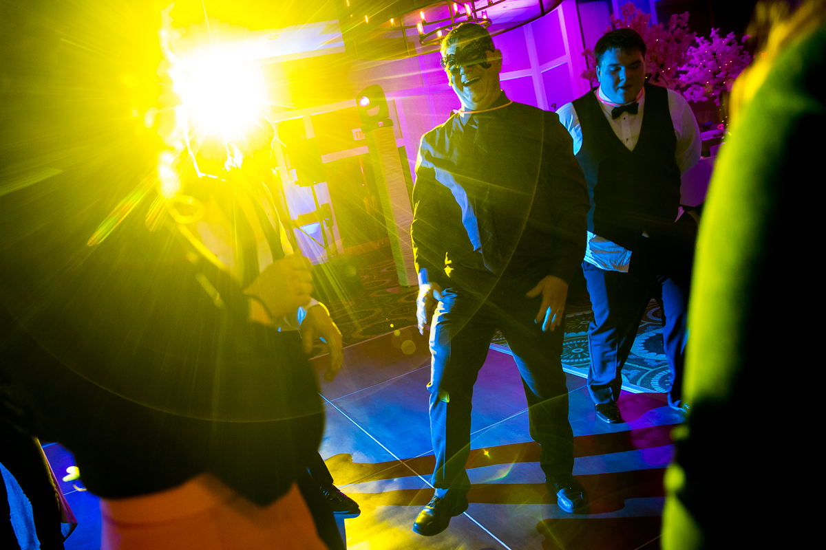 Colorful, creative and vibrant photo of the guest dancing at the wedding reception