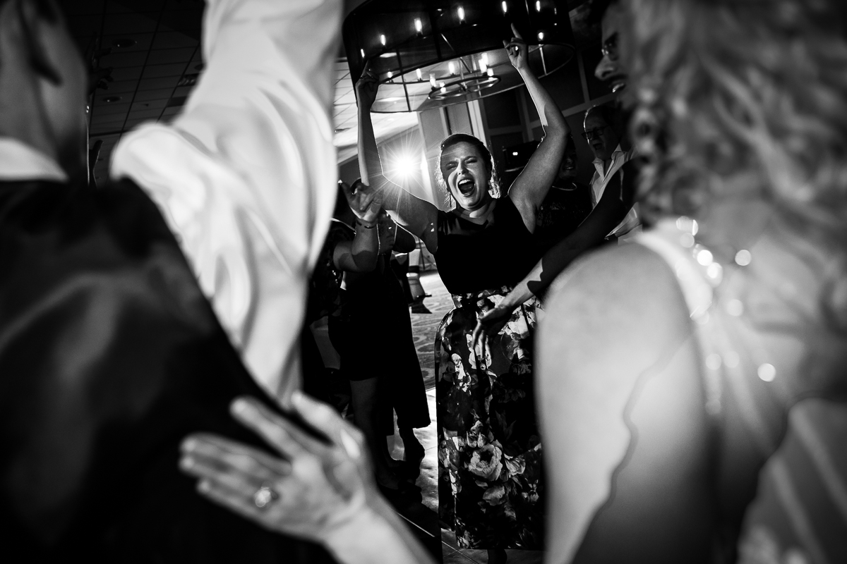 Black and white creative photo of guests dancing during the wedding reception