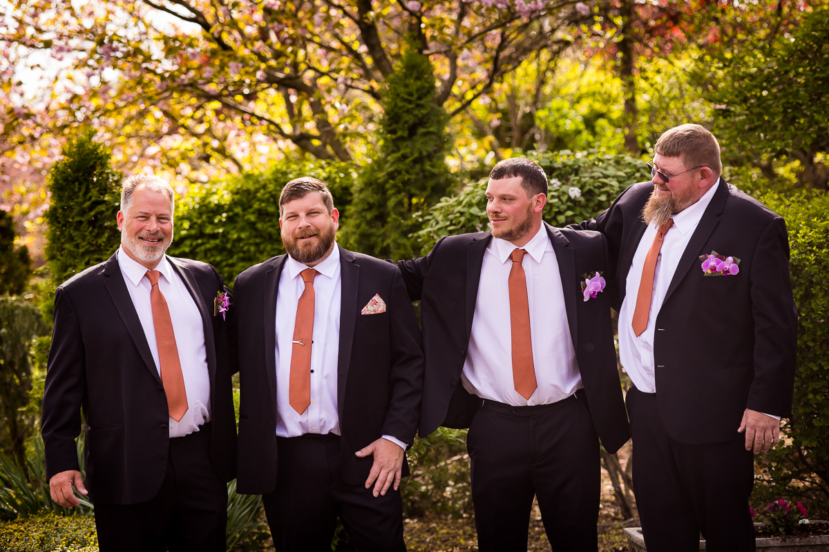 candid image of the groom and groomsmen together laughing and smiling before the ceremony at linwood estate 