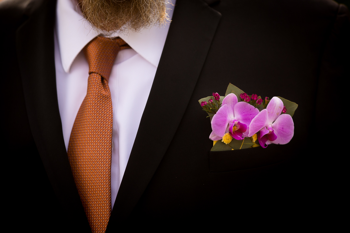 unique vibrant image of the grooms orchid boutonniere before this wedding in carlisle pa 