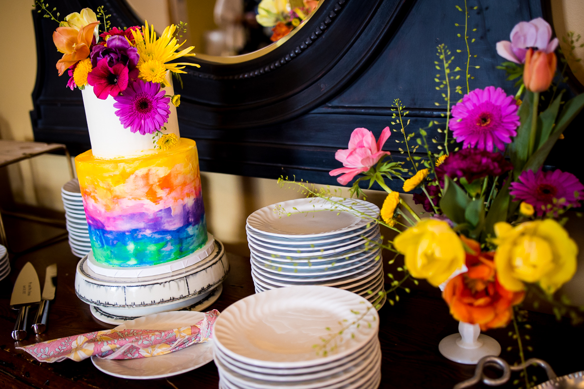 colorful, vibrant image of the wedding cake and decor for this linwood estate wedding reception