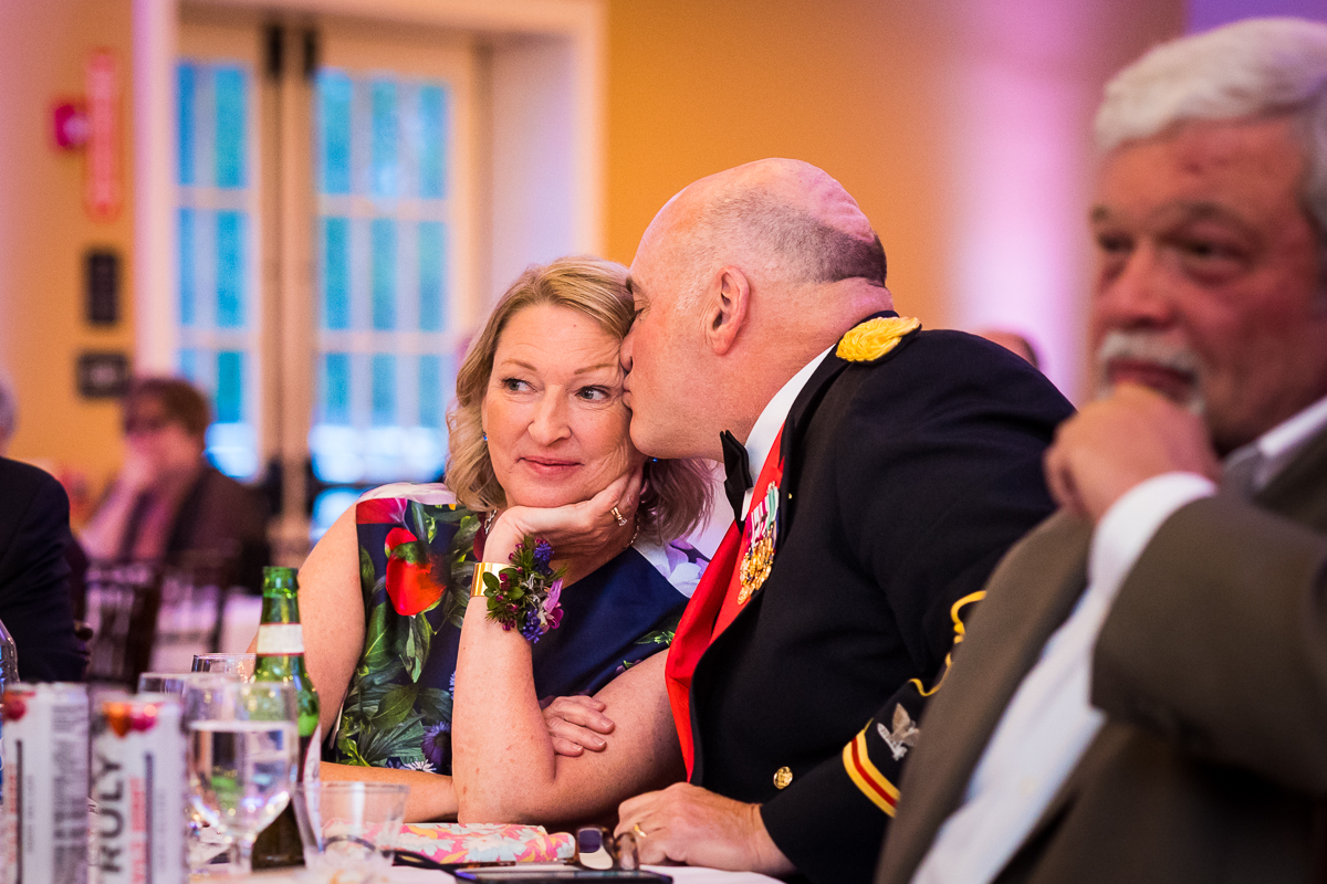 vibrant image of the father of the bride kissing his wife during this linwood estate wedding reception