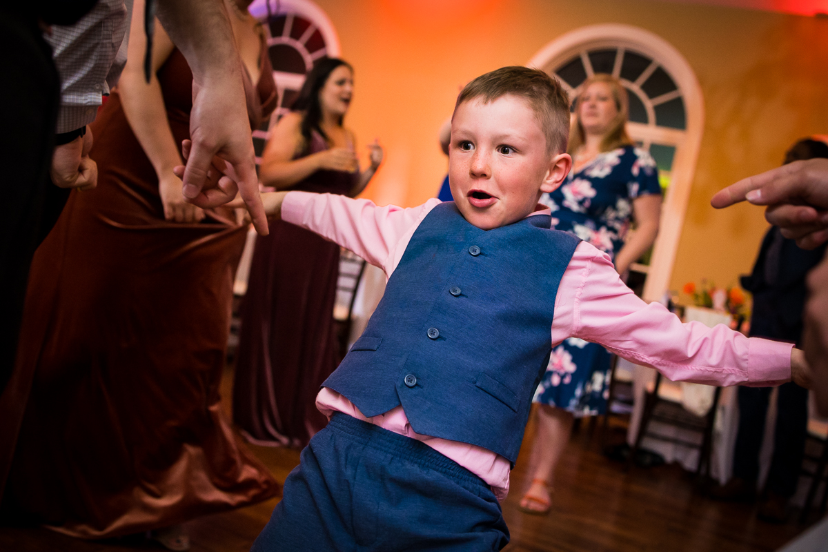 image of a little boy dancing on the dance floor during this wedding ceremony