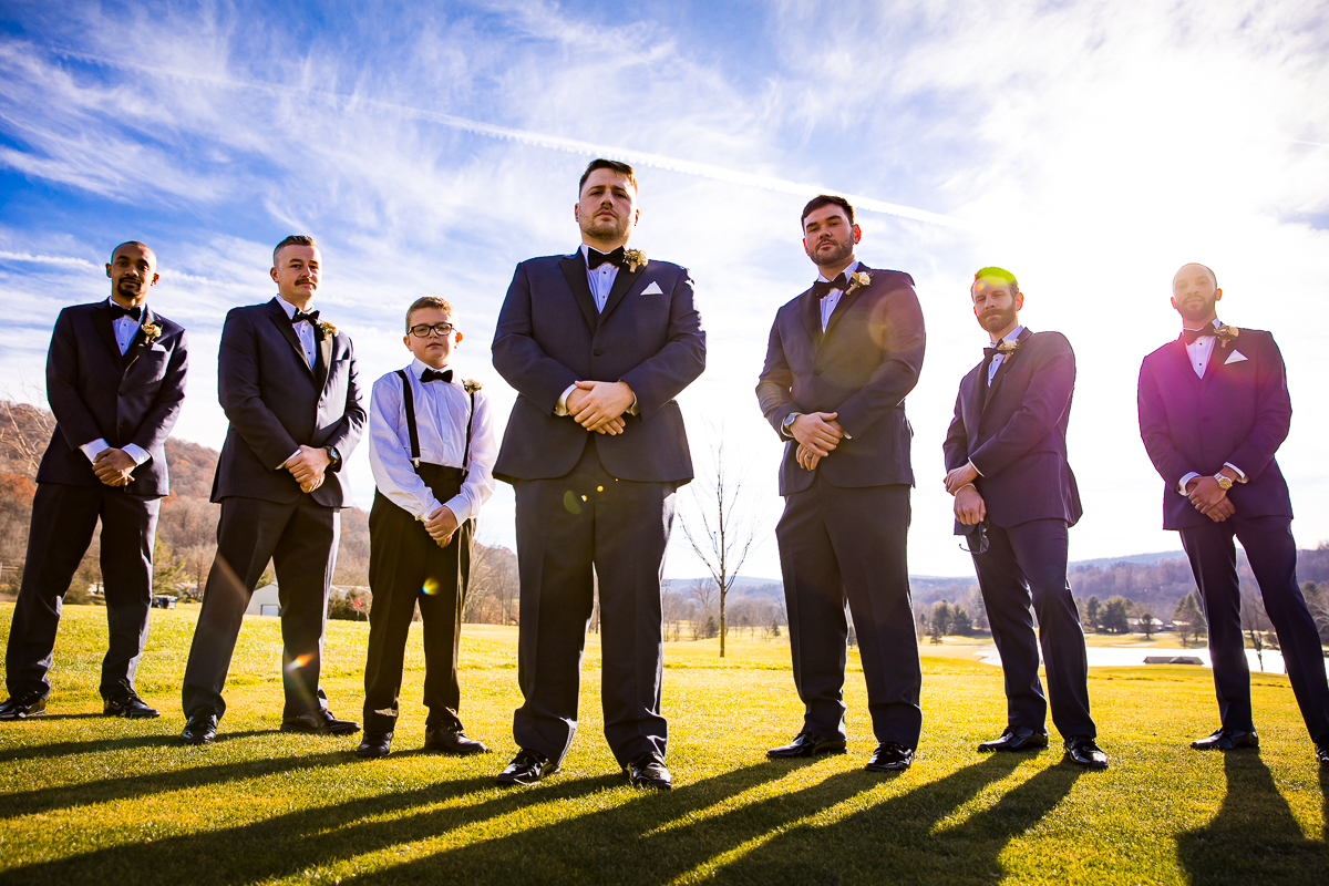 Vibrant, colorful images of the groomsmen standing with their hands crossed before this liberty mountain resort wedding ceremony