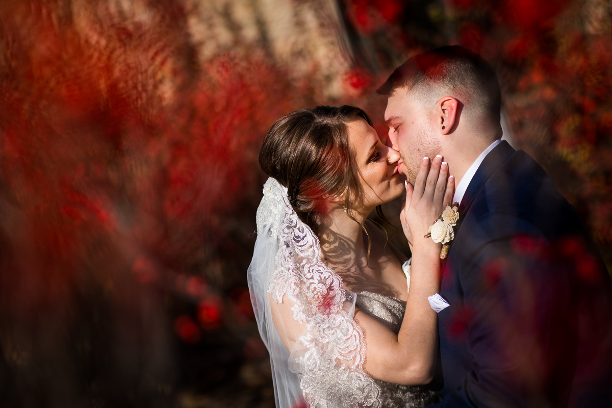 unique, creative, vibrant red photo of the bride and groom kissing each other before their liberty mountain resort wedding ceremony