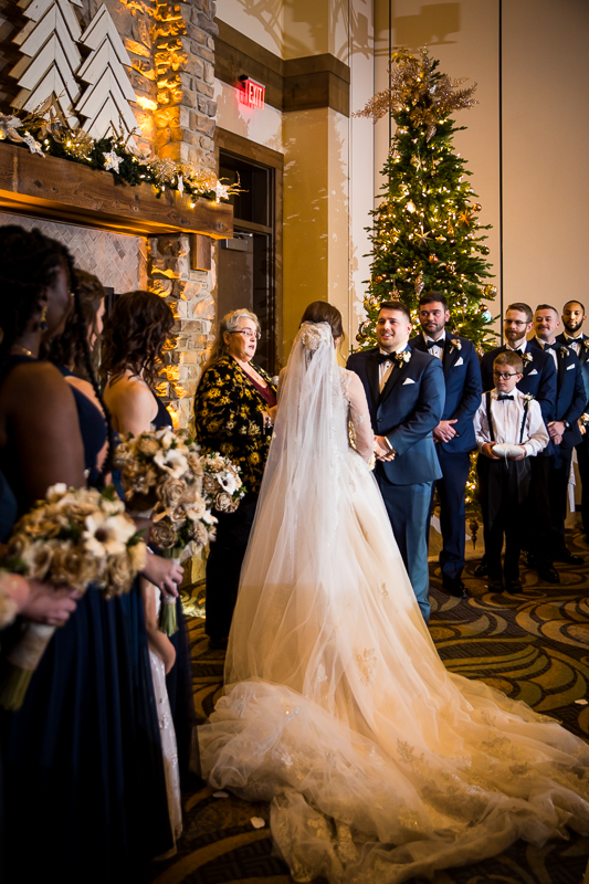 warm toned traditional image of the bride and groom looking at one another during their wedding ceremony at Liberty Mountain resort