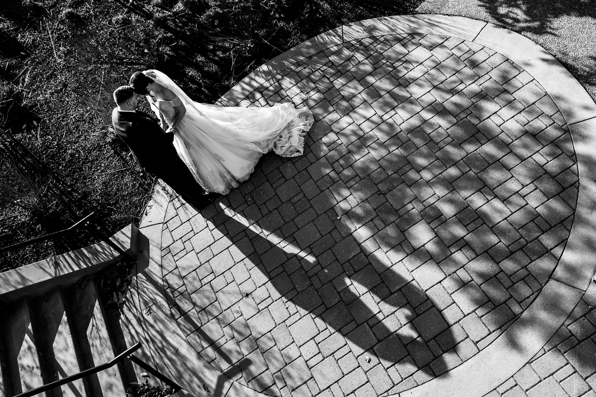 Unique over head shot of the bride and groom holding hands and touching heads during their romantic portraits before their liberty mountain resort wedding with central pa wedding photographer Lisa Rhinehart