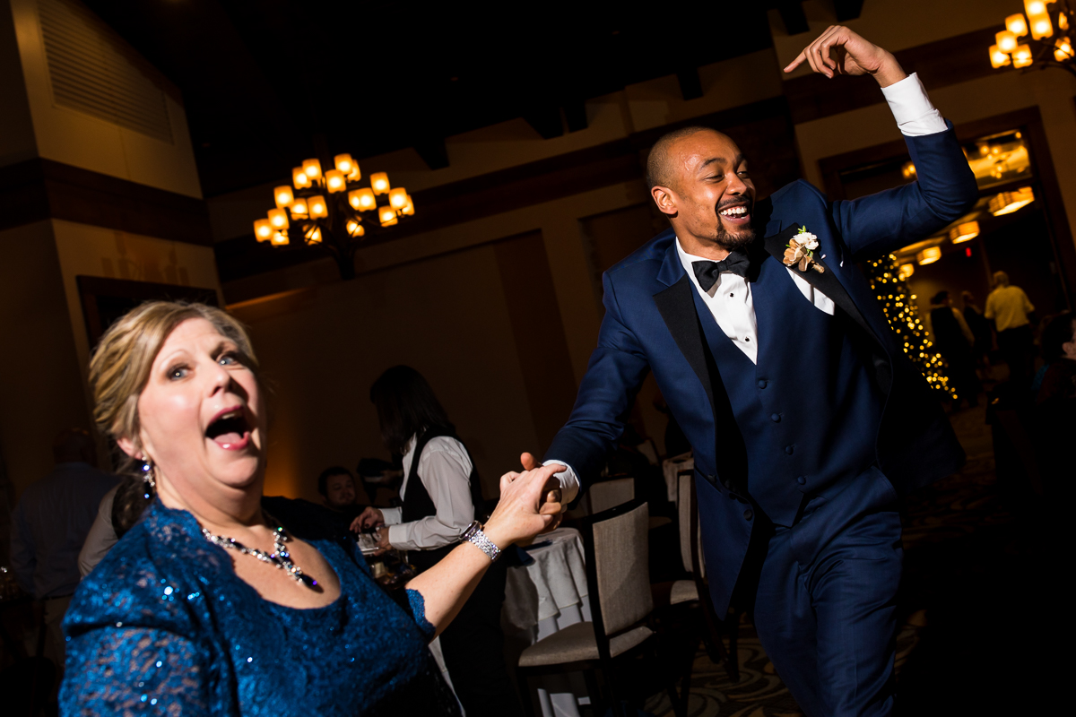 image of the groom's mom and groomsmen dancing together during this liberty mountain wedding reception