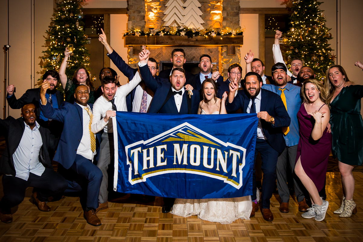 image of the bride and groom with their friends from Mount St Mary's University taken at their liberty mountain resort wedding reception Gettysburg pennsylvania