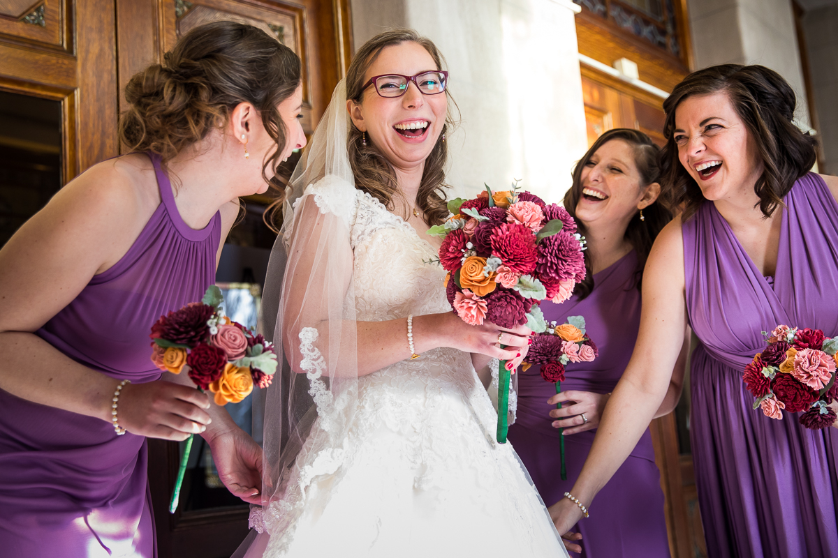 candid, colorful photo of the bride and her bridesmaids laughing and smiling before the wedding with creative photographer lisa rhinehart